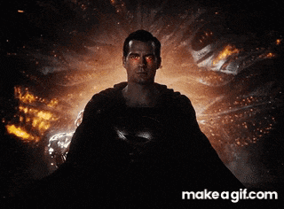 a man in a superman costume is standing in front of a red light