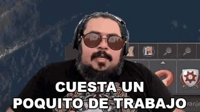 a man with a beard and sunglasses is wearing headphones and a t-shirt .