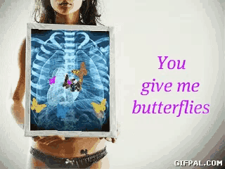 a woman is holding an x-ray of her chest with butterflies on it and the words you give me butterflies
