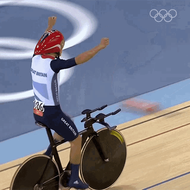 a great britain athlete is riding a bike