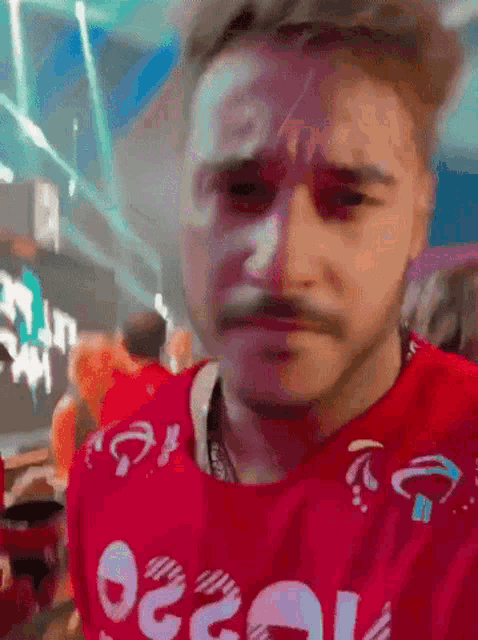 a man is wearing a red shirt with the word ocean on the front
