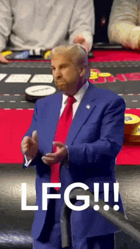 a man in a blue suit and red tie says lfg