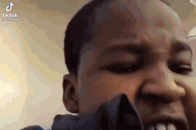 a close up of a person 's face with their mouth open and their eyes closed .
