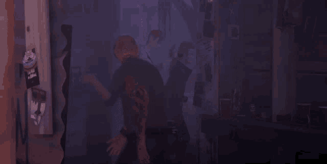 a group of people are dancing in a dark room with purple lights .