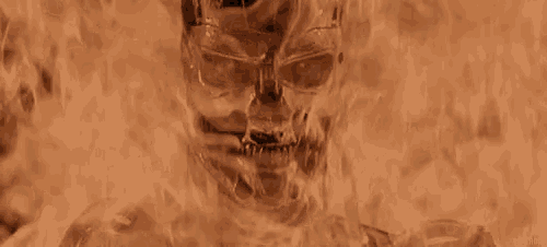 a skull is surrounded by flames and smoke in a dark room .