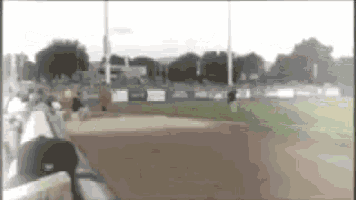 a baseball game is being played on a field with a blurred background .