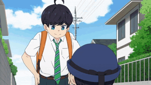 a boy with a backpack and tie stands next to another boy with a hat