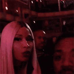 a woman is blowing a kiss on a man 's cheek .