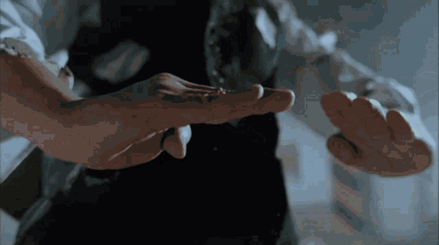 a close up of a person 's hands reaching out
