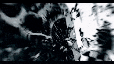 a black and white image of a bullet going through a hole in the ground .