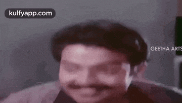 a man with a mustache is making a funny face in a movie .