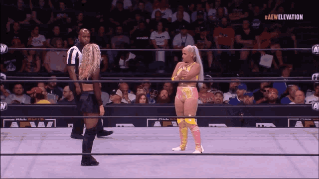 two women in a wrestling ring with #aew elevation on the bottom right