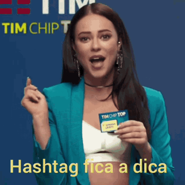 a woman in a blue jacket is holding a tim chip