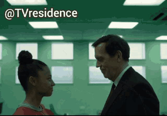 a man and a woman are looking at each other in a green room with the words @tvresidence behind them
