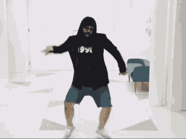 a man wearing a 1996 shirt is dancing