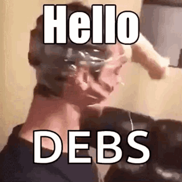 a man with a mask on his head is holding his hand to his forehead and says `` hello debs '' .