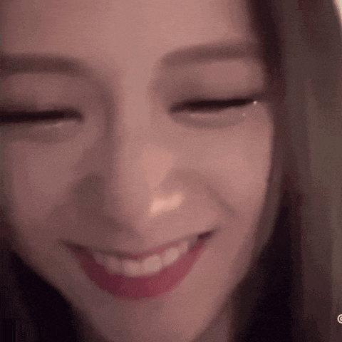 a close up of a woman smiling with her eyes closed .