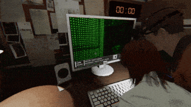 a man and woman are looking at a computer screen which says cam on it