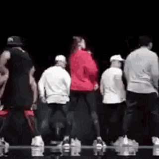 a group of people are dancing together on a stage .