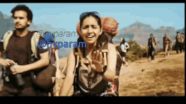 a group of people are walking on a dirt road and the word hyparam is on the bottom left
