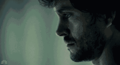 a close up of a man 's face with a nbc logo on the bottom