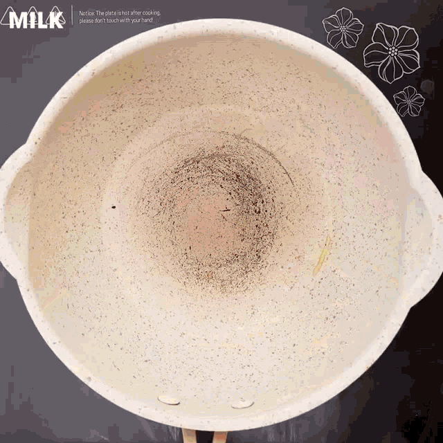 a white bowl with the word milk on the bottom of it