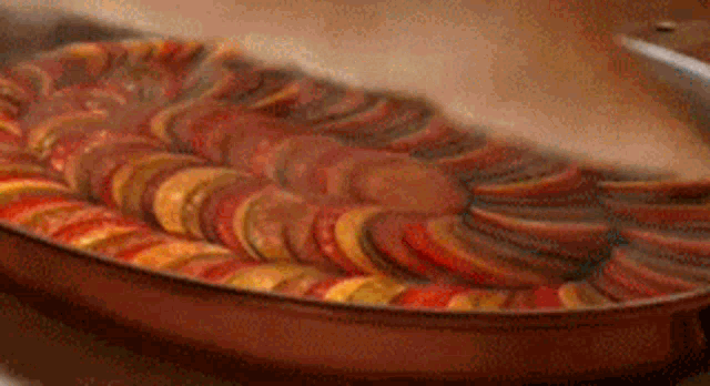 a pan filled with sliced fruits and vegetables