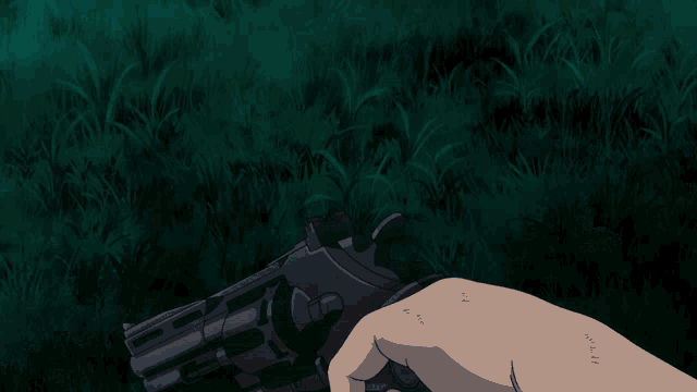 a person is holding a gun in front of a laptop that has the letter o on the keyboard