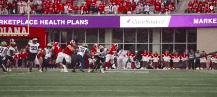 a football game is being played in front of a banner that says caresource