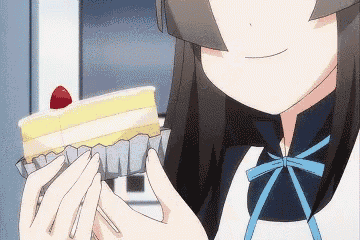 a girl is holding a piece of cake with a strawberry on top ..