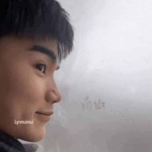 a close up of a young man 's face with a blurred background .