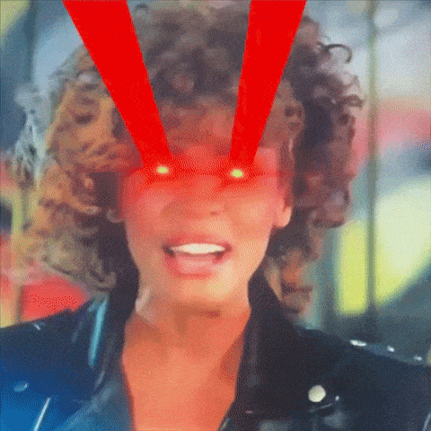 a close up of a woman 's face with red light coming out of her eyes