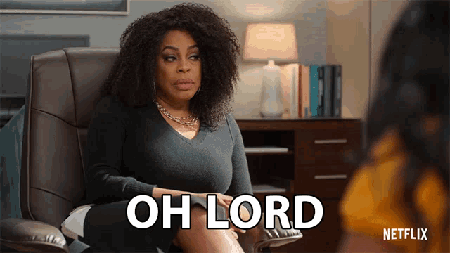 a woman sits in a chair with the words oh lord written on the screen