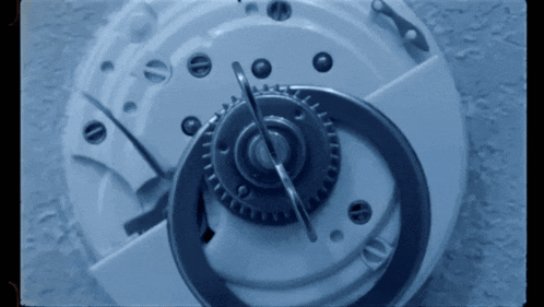 a close up of a clock face with a clock needle pointing to the number 12