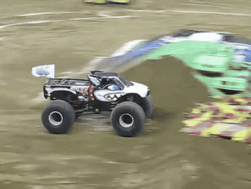 a monster truck with a flag on the back that says ' snake ' on it