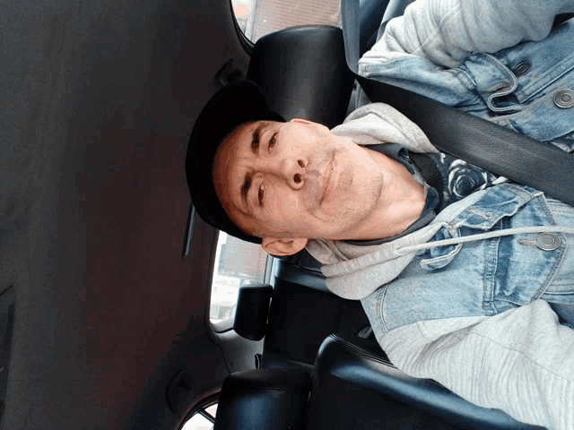 a man is sitting in the back seat of a car