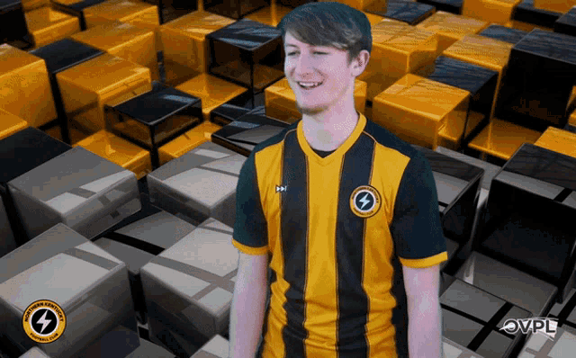 a man wearing a yellow and black shirt with a lightning bolt on the front