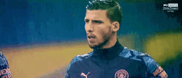 a man in a soccer jersey is standing on a field .