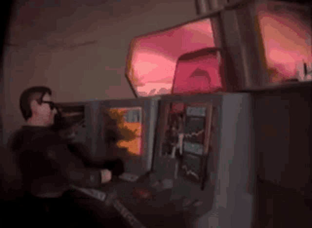 a man is playing a video game with a red light behind him that says ' stealth wing '