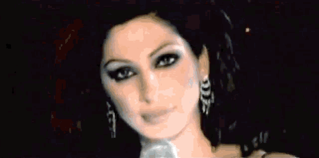 a blurry picture of a woman wearing earrings