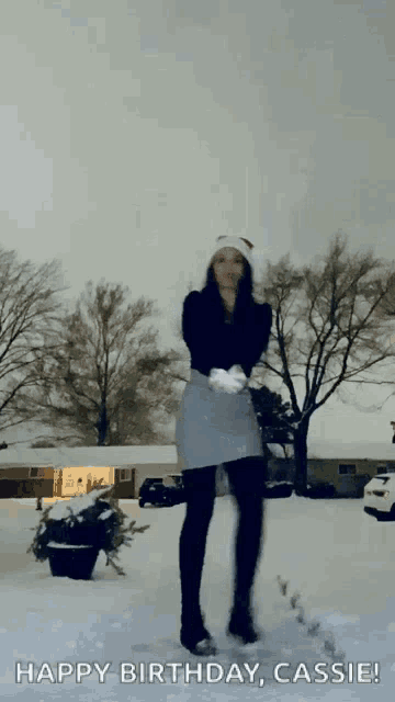 a woman standing in the snow with the words happy birthday cassie written on the bottom