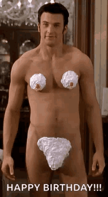 a shirtless man with whipped cream on his breasts and underwear is standing in a room .