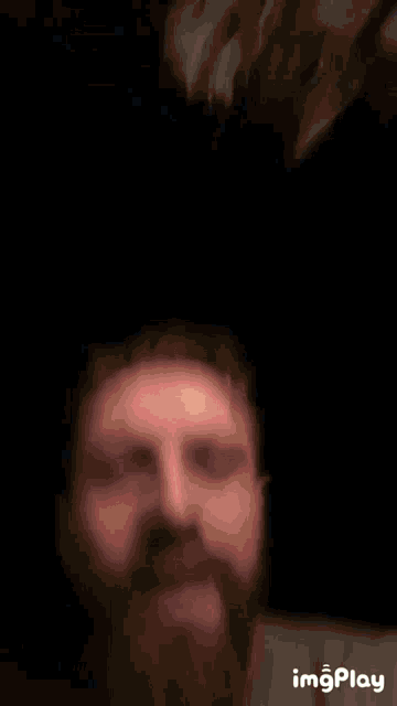 a man with a beard is making a funny face in a gif that says imgplay at the bottom