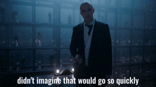 a man in a suit and tie is standing in a dark room with the words didn 't imagine that would go so quickly