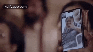 a woman is taking a picture of herself on her phone .
