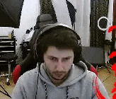 a man wearing headphones is sitting in a chair and looking at the camera .