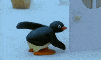 a penguin with wings is standing next to a wall