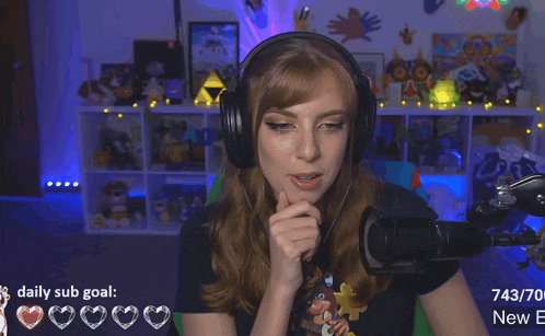 a woman wearing headphones is sitting in front of a microphone with a daily sub goal