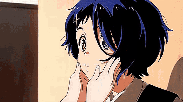 a girl with blue hair is touching her face with her hands