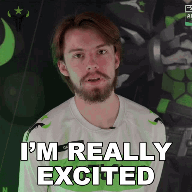 a man with a beard says i 'm really excited in front of a green background